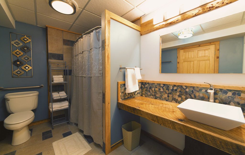Ski Inn bathroom with stone and wood details